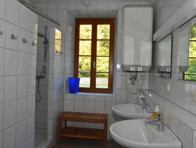 Das Bad unten bietet zwei Toiletten, zwei Duschen sowie zwei Waschbecken.